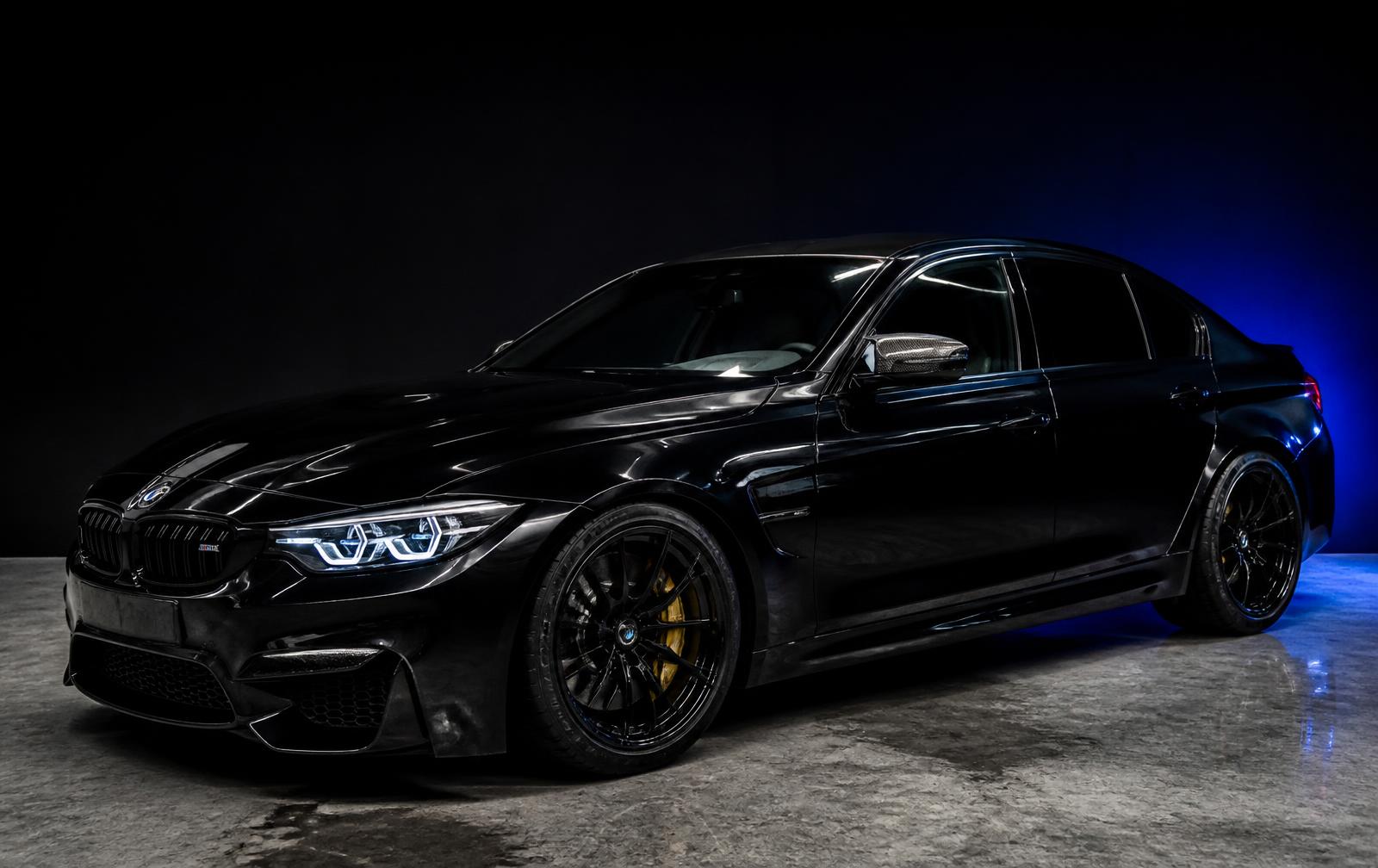 Freshly detailed black luxury car with mirror-gloss paint